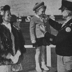 5-year-old Sharon Vance is presented with her father's Medal of Honor in 1946. US Army Photograph.