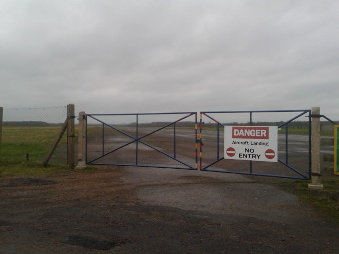 At the end of the Peterborough Business Airport's runway, still in use from the Second World War as a general aviation facility. A marker placed at the foot of the watertower, which is a moving remembrance to the men who paid the ultimate sacrifice flying from RAF Glatton in the Second World War.  © Brandon Wilgus, 2015.