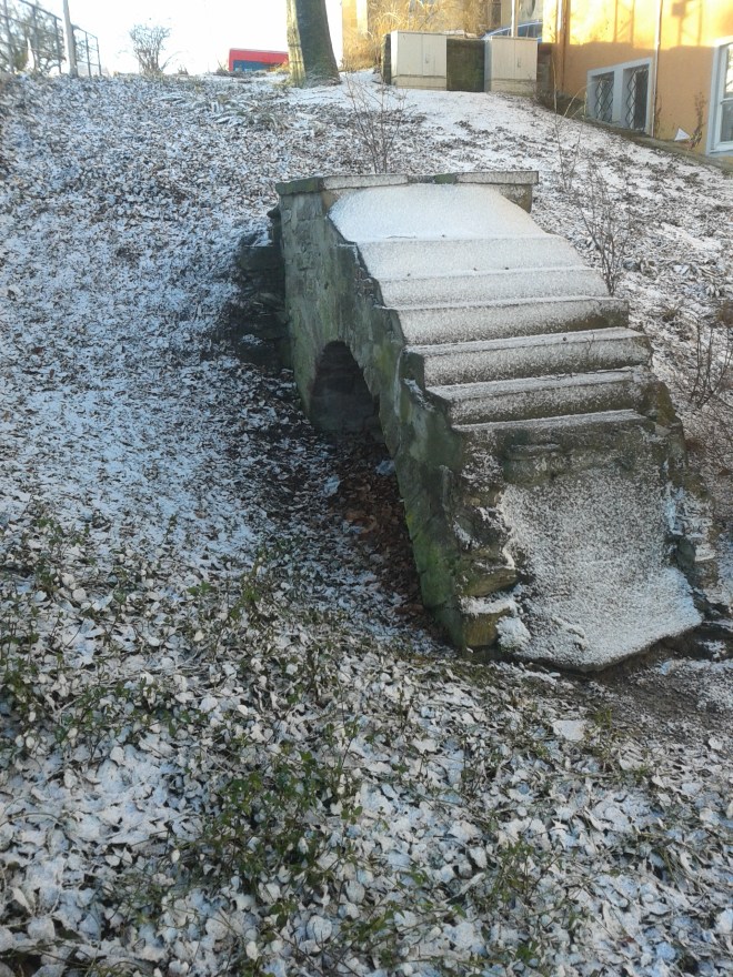 A small piece of the Boblingen castle, completely destroyed on the night of 7 October 1943.  This piece of archway lies buried in the hillside. © Brandon Wilgus, 2015.
